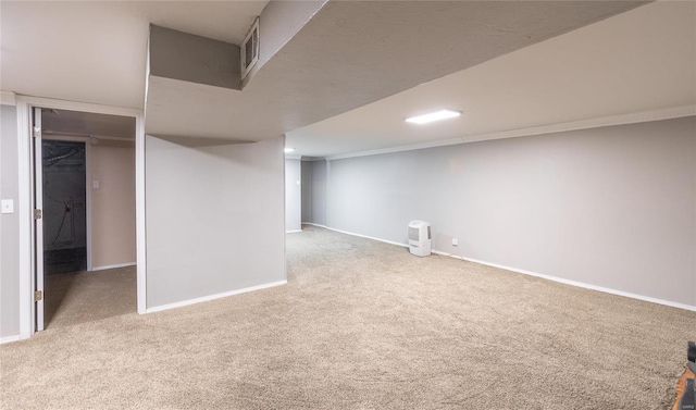 finished basement with carpet floors, visible vents, and baseboards