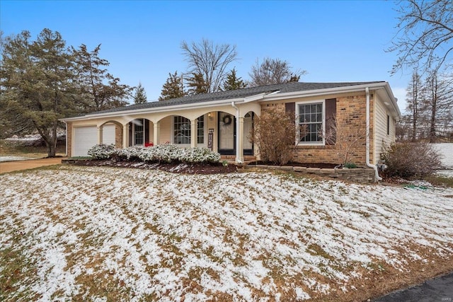 ranch-style house featuring an attached garage, a porch, and brick siding