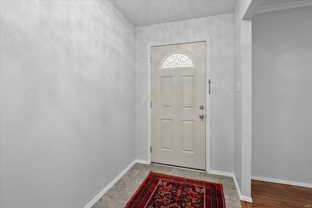 doorway to outside featuring baseboards