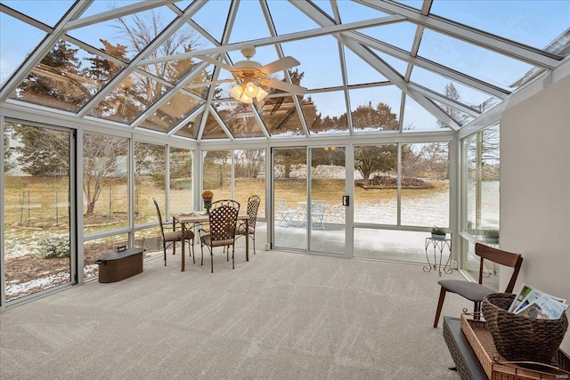 sunroom with a water view and ceiling fan