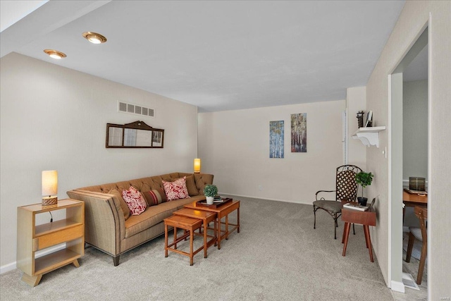 carpeted living room with visible vents and baseboards