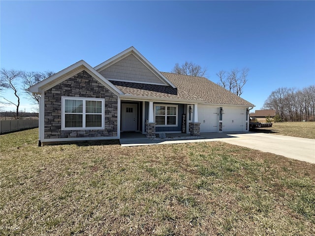 view of front of property featuring stone siding, concrete driveway, a front yard, a shingled roof, and a garage