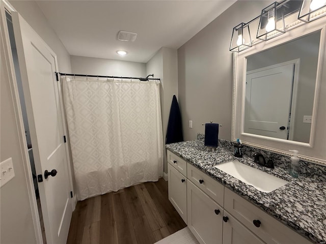 full bathroom featuring vanity, shower / bathtub combination with curtain, and wood finished floors