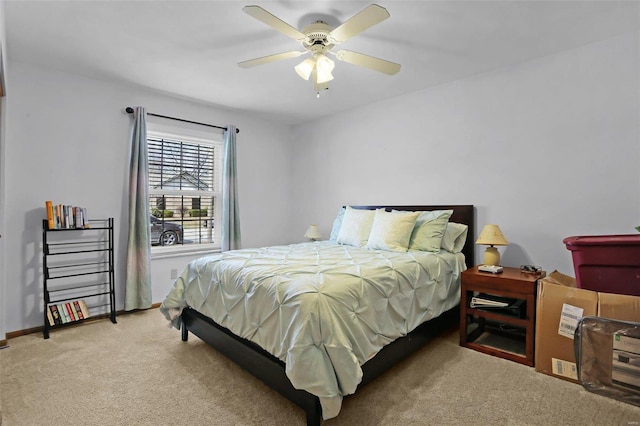 carpeted bedroom featuring ceiling fan and baseboards