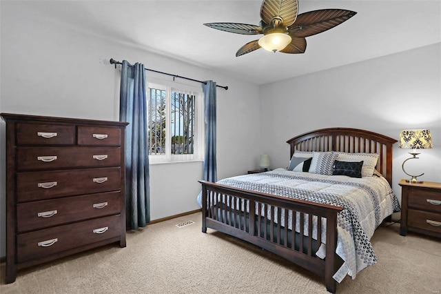 bedroom featuring light carpet, ceiling fan, visible vents, and baseboards