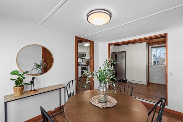 dining area with wood finished floors