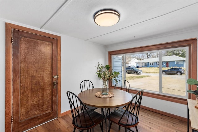 dining area with baseboards and light wood-style floors