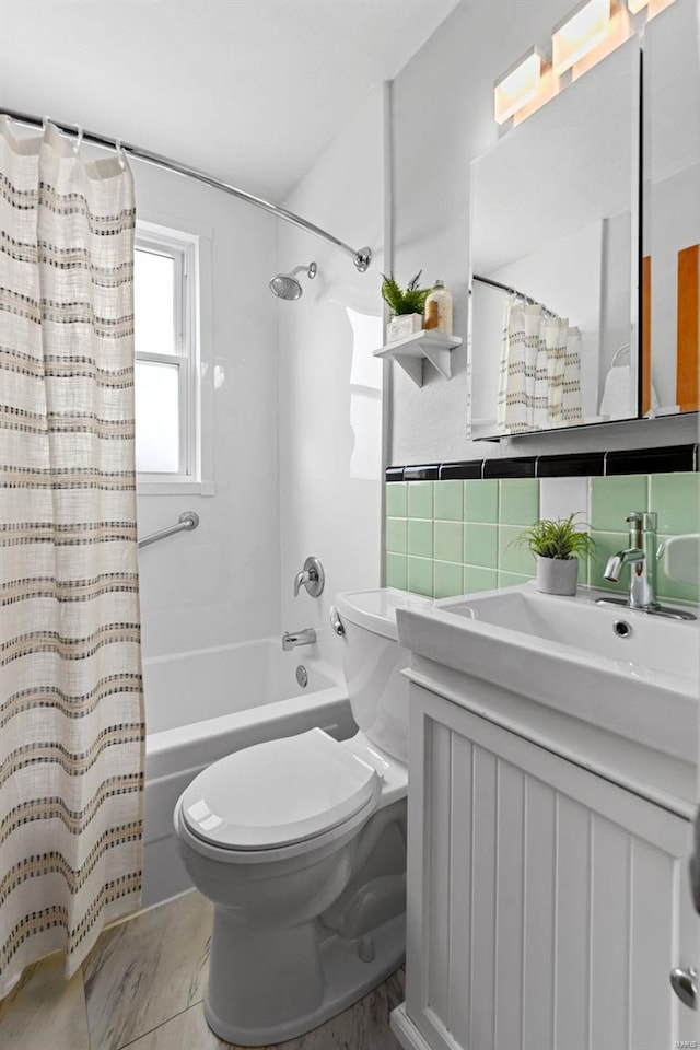 full bath with shower / bath combo, vanity, toilet, and decorative backsplash