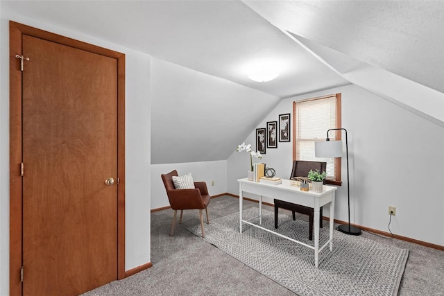 office featuring lofted ceiling, carpet, and baseboards