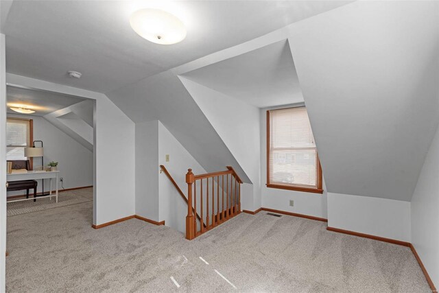 bonus room with carpet, lofted ceiling, and baseboards