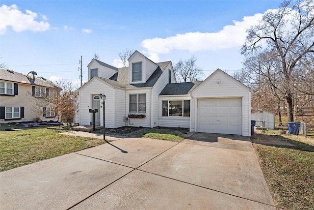 cape cod-style house with roof with shingles, concrete driveway, a front yard, fence, and a garage