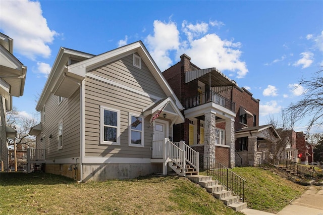 view of front of property featuring crawl space, a front yard, and a balcony