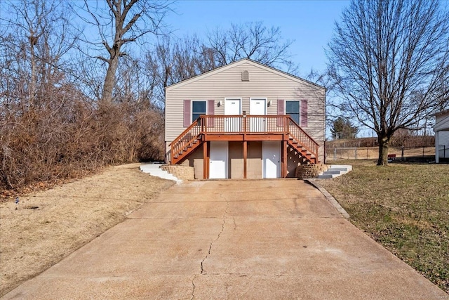 view of front facade featuring driveway and stairs