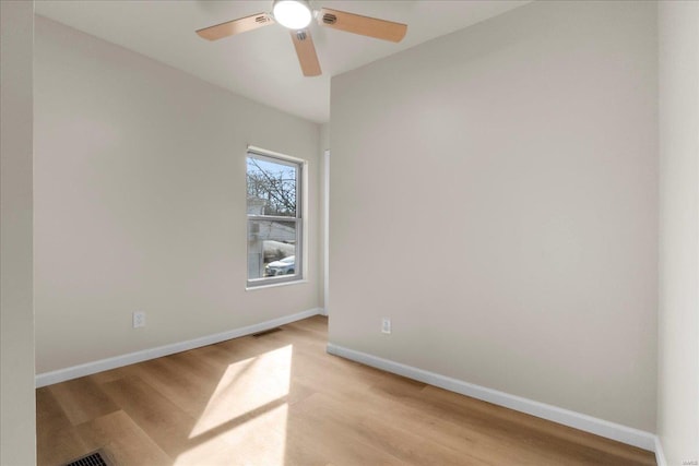 unfurnished room featuring light wood-style floors, visible vents, ceiling fan, and baseboards