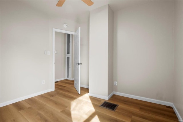 unfurnished bedroom featuring visible vents, baseboards, and wood finished floors