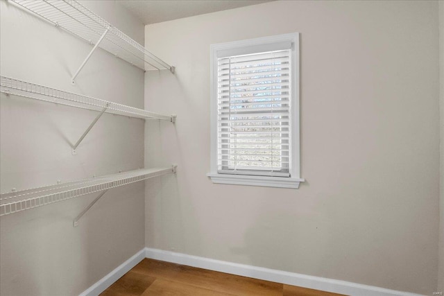 spacious closet with wood finished floors