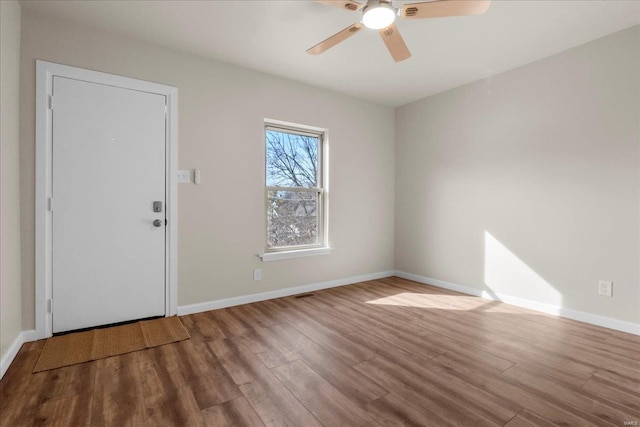 entryway with a ceiling fan, baseboards, and wood finished floors