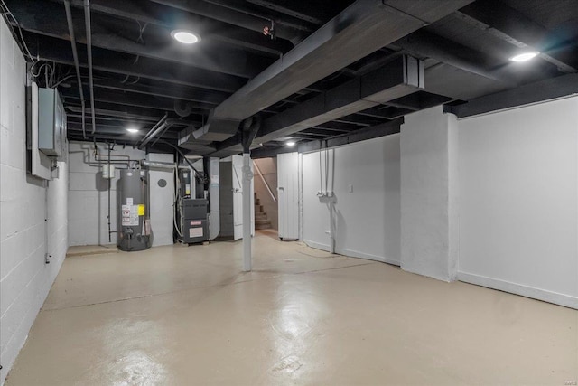 unfinished below grade area featuring water heater, stairway, and heating unit