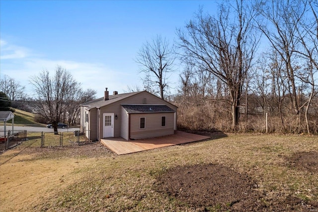 view of outbuilding featuring fence