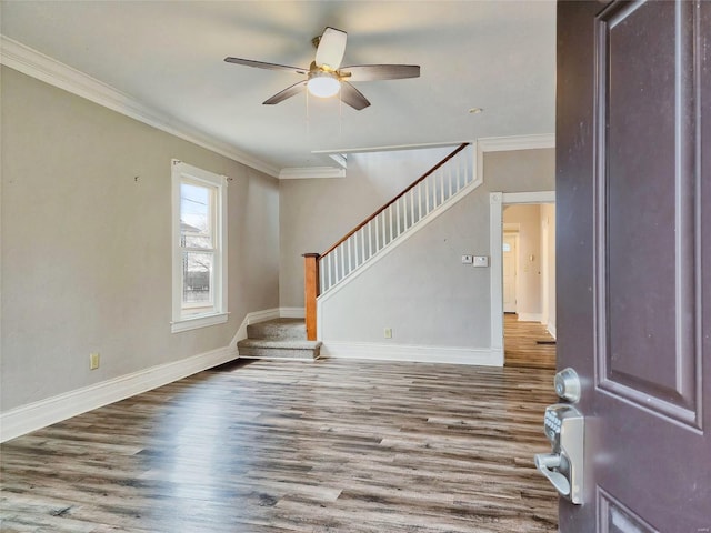 interior space with ornamental molding, stairway, and wood finished floors