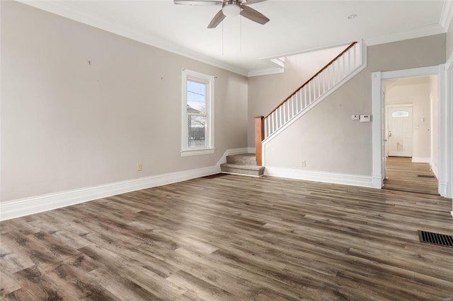 unfurnished living room with visible vents, crown molding, stairway, and wood finished floors