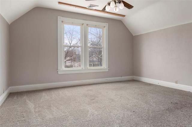 additional living space featuring visible vents, baseboards, a ceiling fan, lofted ceiling, and carpet floors