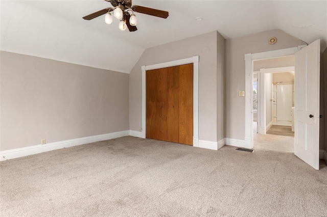 additional living space featuring lofted ceiling, ceiling fan, carpet flooring, visible vents, and baseboards