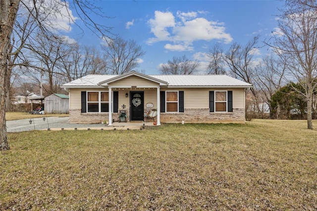 ranch-style house featuring a porch, brick siding, metal roof, and a front lawn