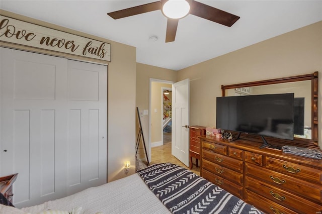 bedroom with ceiling fan, a closet, and wood finished floors