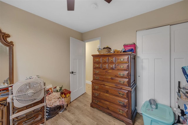 interior space featuring light wood-type flooring, ceiling fan, and a closet