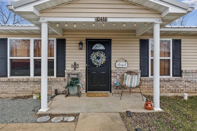 property entrance featuring brick siding