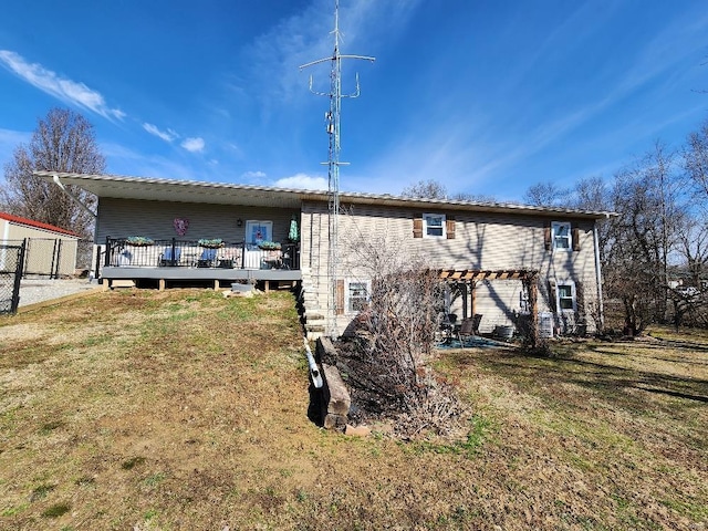 rear view of house with fence, a lawn, a pergola, and a wooden deck