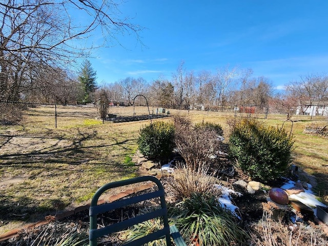 view of yard featuring fence and a rural view