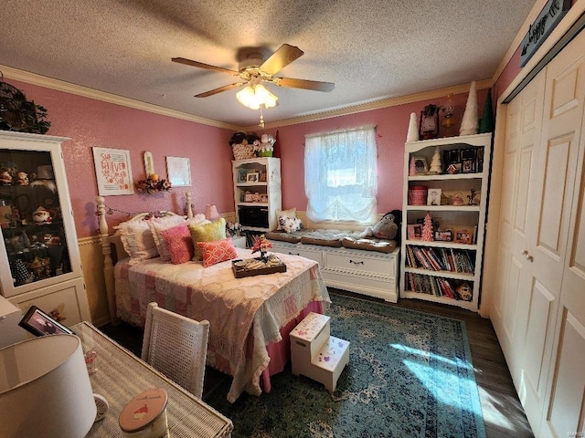 bedroom with dark wood-style floors, a closet, crown molding, and a textured ceiling