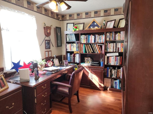 office space featuring a ceiling fan and wood finished floors