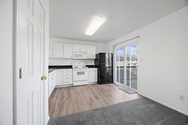 kitchen with dark countertops, white appliances, white cabinetry, and light wood finished floors