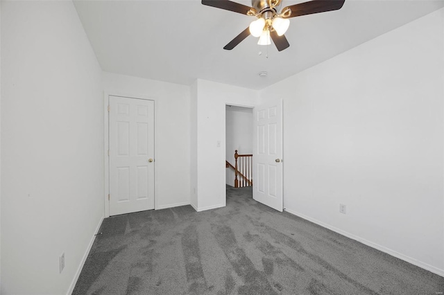 unfurnished bedroom featuring a ceiling fan, carpet flooring, and baseboards