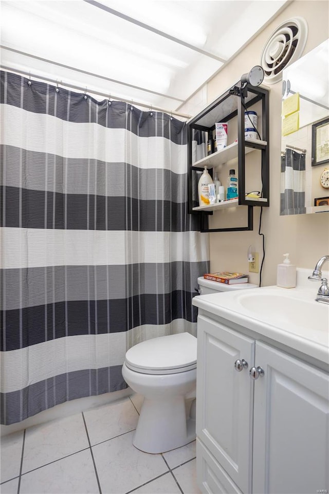 full bathroom with curtained shower, vanity, toilet, and tile patterned floors