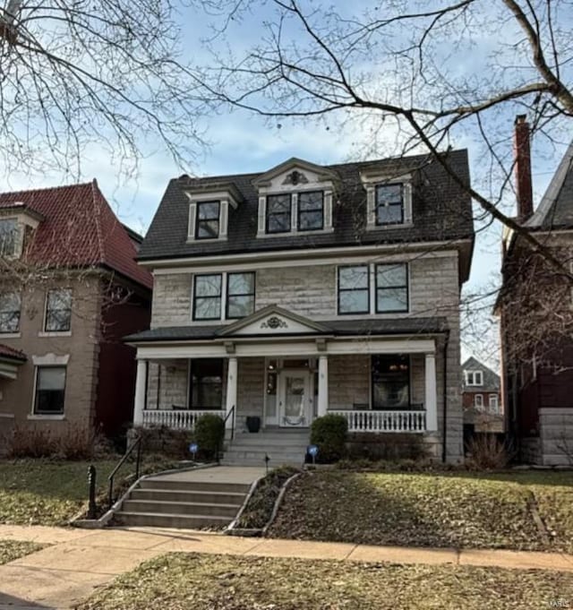 view of front of home with stone siding and covered porch