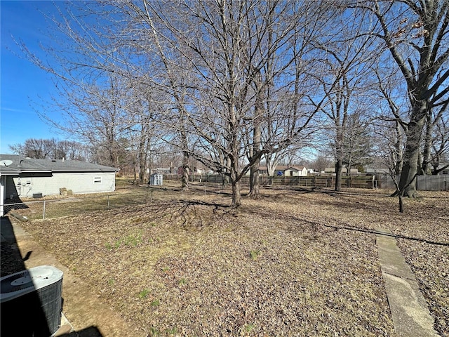 view of yard featuring cooling unit and fence