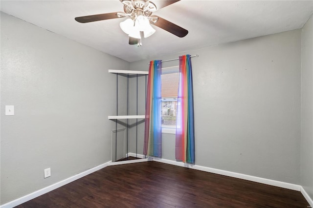 spare room with a ceiling fan, wood finished floors, and baseboards