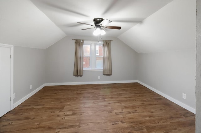 bonus room featuring vaulted ceiling, a ceiling fan, baseboards, and wood finished floors