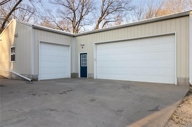 garage featuring concrete driveway