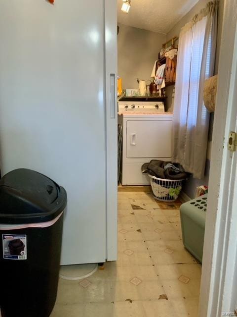 washroom featuring washer / dryer, laundry area, and light floors