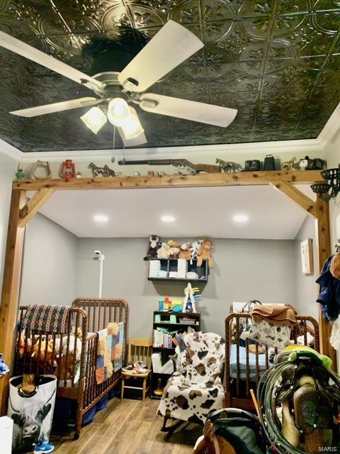 bedroom featuring an ornate ceiling and wood finished floors