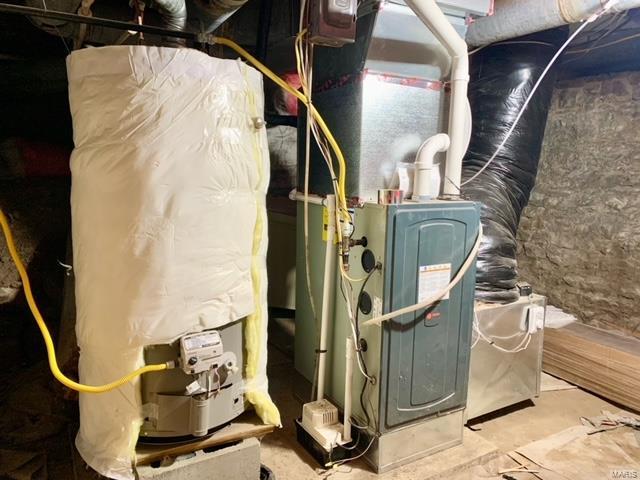 utility room with water heater and heating unit