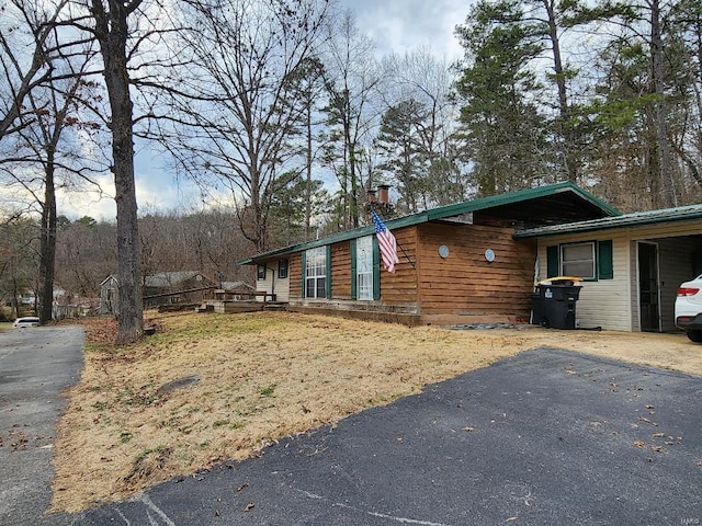 view of side of home with driveway