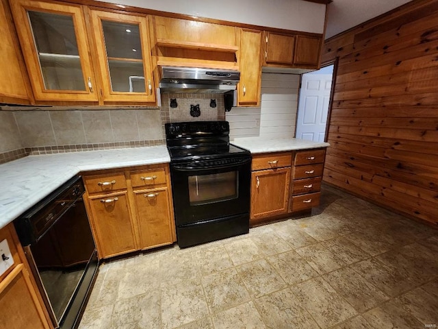 kitchen with brown cabinets, range hood, light countertops, and black appliances