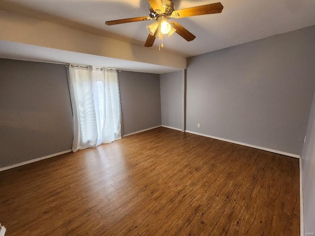 unfurnished room with a ceiling fan, baseboards, and wood finished floors