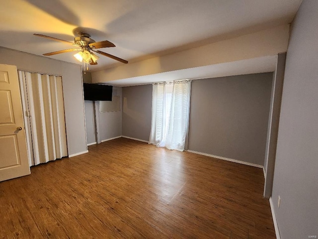 unfurnished bedroom featuring ceiling fan, baseboards, and wood finished floors